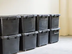 Man Sat On Couch With Wife's Body In Plastic Bins